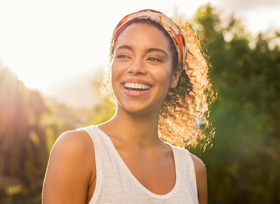 A smiling girl with hair band and curly hair