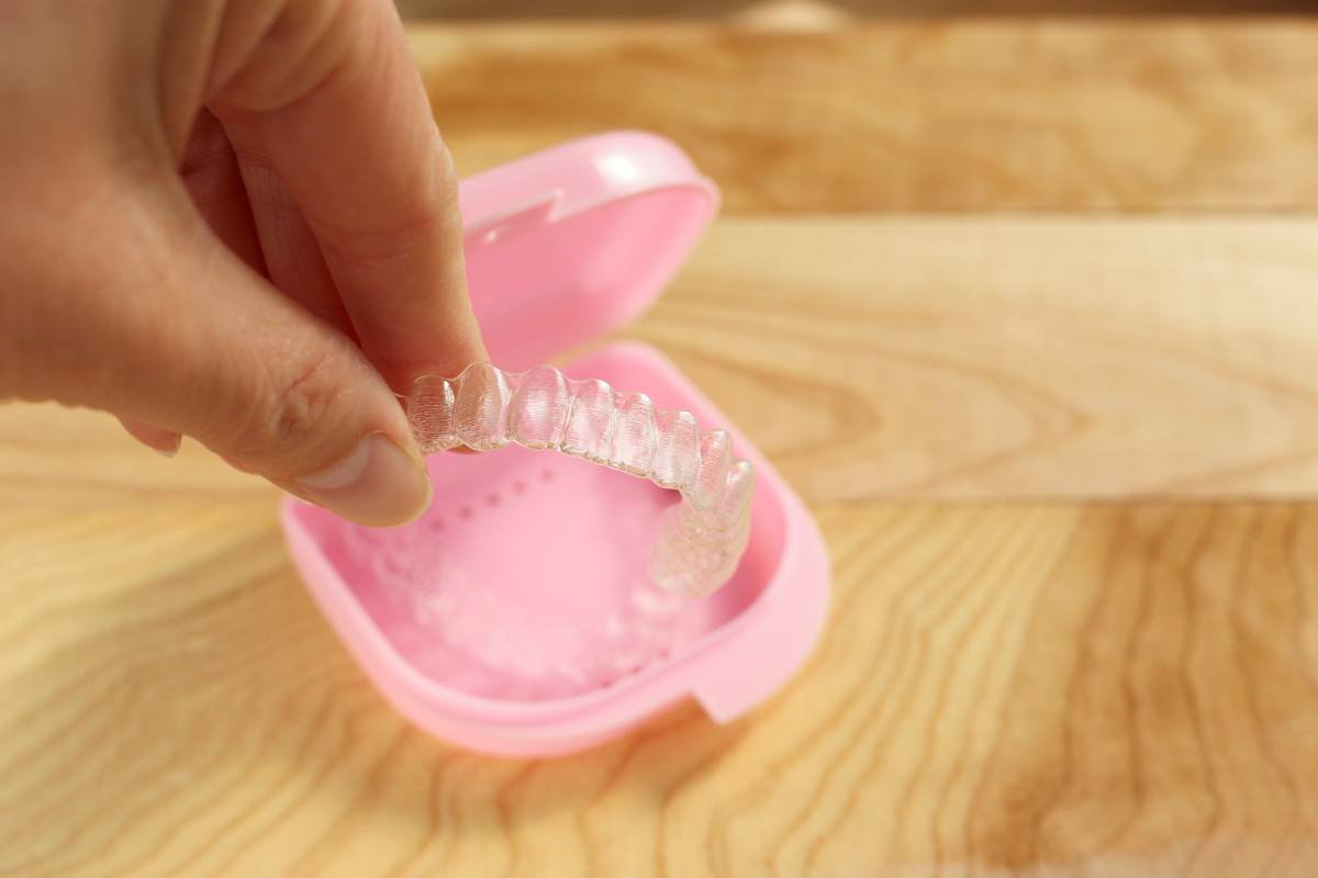 Hand and mouthpiece a wooden table