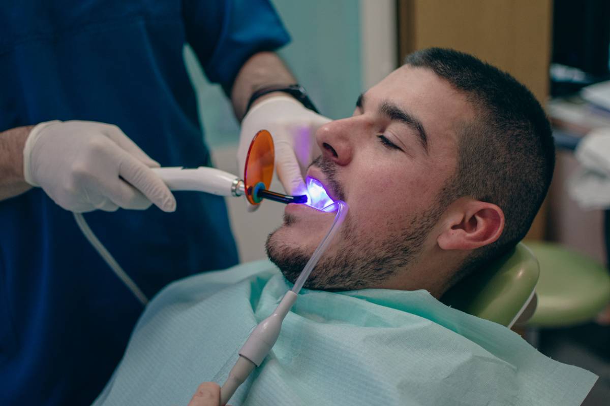 bonding the filling to the tooth with a polymerization lamp at the dentist